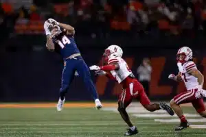 Illinois Fighting Illini wide receiver Casey Washington (14) makes a catch against Nebraska Cornhuskers Quinton Newsome (6) during a college football game in Lincoln, Nebraska, Friday, October 6, 2023. Photo by John Peterson.