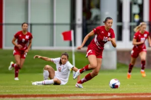 Nebraska Cornhuskers Florence Belzile (10) takes the ball away from Maryland Terrapins midfielder Catherine DeRosa (13) in the first half during a college soccer match Thursday, October 12, 2023, in Lincoln, Neb. Photo by John S. Peterson.
