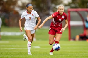 Nebraska Cornhuskers Sadie Waite (11) beats out Maryland Terrapins midfielder Ava Morales (2) for the ball in the first half during a college soccer match Thursday, October 12, 2023, in Lincoln, Neb. Photo by John S. Peterson.