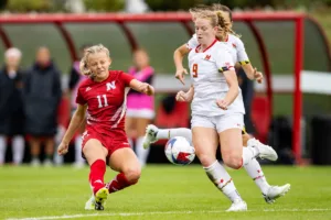 Nebraska Cornhuskers Sadie Waite (11) takes a shot against Maryland Terrapins defender Katie Coyle (9) in the first half during a college soccer match Thursday, October 12, 2023, in Lincoln, Neb. Photo by John S. Peterson.