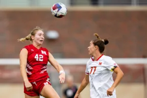 Nebraska Cornhuskers Sarah Weber (42) heads the ball against Maryland Terrapins defender Caroline Koutsos (77) in the first half during a college soccer match Thursday, October 12, 2023, in Lincoln, Neb. Photo by John S. Peterson.