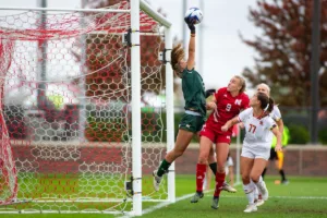 Maryland Terrapins goalkeeper Liz Beardsley (17) blocks a shot with Nebraska Cornhuskers Eleanor Dale (9) trying to make an opportunity in the second half during a college soccer match Thursday, October 12, 2023, in Lincoln, Neb. Photo by John S. Peterson.