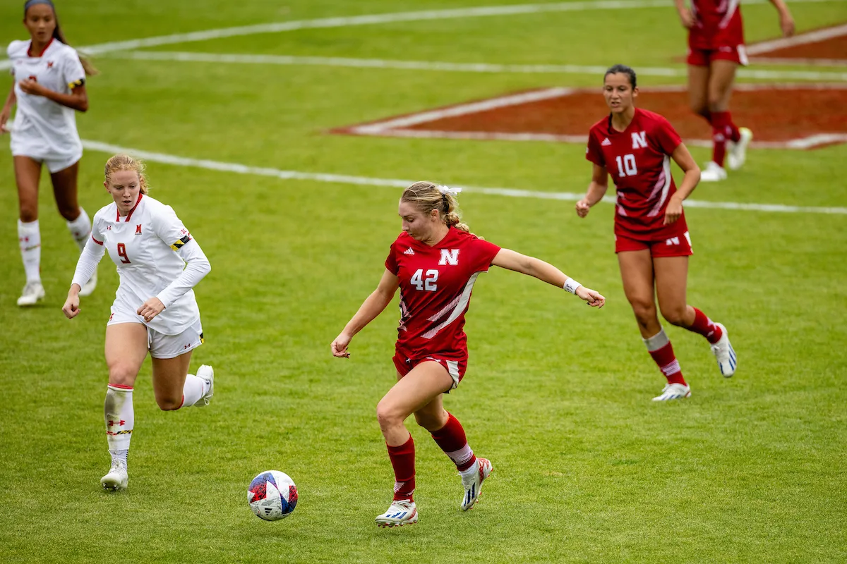 Nebraska Cornhuskers Sarah Weber (42) on the attack against Maryland Terrapins defender Katie Coyle (9) in the second half during a college soccer match Thursday, October 12, 2023, in Lincoln, Neb. Photo by John S. Peterson.