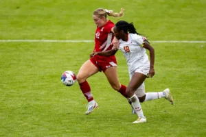 Nebraska Cornhuskers Sarah Weber (42) fends off Maryland Terrapins defender Kennedy Bell (18) while dribbling the ball in the second half during a college soccer match Thursday, October 12, 2023, in Lincoln, Neb. Photo by John S. Peterson.