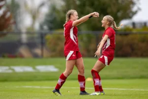 Nebraska Cornhuskers Eleanor Dale (9) gets a hug from Sadie Waite (11) after scoring against the Maryland Terrapins in the ssecond half during a college soccer match Thursday, October 12, 2023, in Lincoln, Neb. Photo by John S. Peterson.