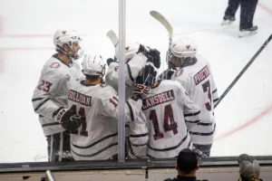 Omaha Mavericks forward Jesse Lansdell (14) celebrates his goal with teammates in the third period against the Niagara Purple Eagles during a college hockey match on Friday, October 13, 2023, in Omaha, Nebraska. Photo by John S. Peterson.