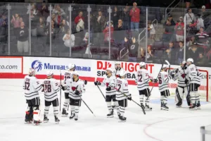 Omaha Mavericks celebrate their win over the Niagara Purple Eagles during a college hockey match on Friday, October 13, 2023, in Omaha, Nebraska. Photo by John S. Peterson.