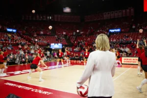 Nebraska Cornhusker assistant coach Jordan Larson watches warm-ups before taking on Penn State Nittany Lions during a college volleyball match on Saturday, October 14, 2023, in Lincoln, Nebraska. Photo by John S. Peterson.