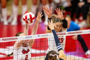 Nebraska Cornhuskers Bergen Reilly (2) and  Andi Jackson (15) block a shot from the Penn State Nittany Lions during a college volleyball match on Saturday, October 14, 2023, in Lincoln, Nebraska. Photo by John S. Peterson.