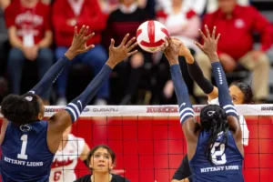 Nebraska Cornhusker Harper Murray (27) spikes the ball against Penn State Nittany Lions Taylor Trammell (1) and Camryn Hannah (8) in the second set during a college volleyball match on Saturday, October 14, 2023, in Lincoln, Nebraska. Photo by John S. Peterson.