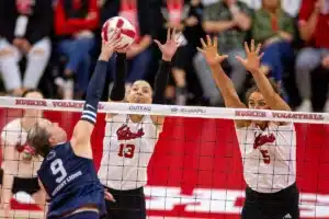 Nebraska Cornhusker Merritt Beason (13) and Bekka Allick (5) block a shot from Penn State Nittany Lions Jess Mruzik (9) in the third set during a college volleyball match on Saturday, October 14, 2023, in Lincoln, Nebraska. Photo by John S. Peterson.