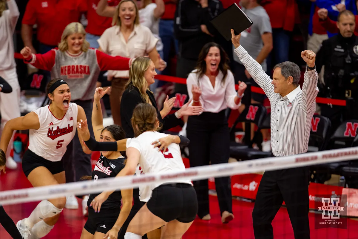 Nebraska Cornhusker head coach John Cook throws his arm up celebrating the win over Wisconsin Badgers in 5 sets during a college volleyball match on Saturday, October 21, 2023, in Lincoln, Nebraska. Photo by John S. Peterson.