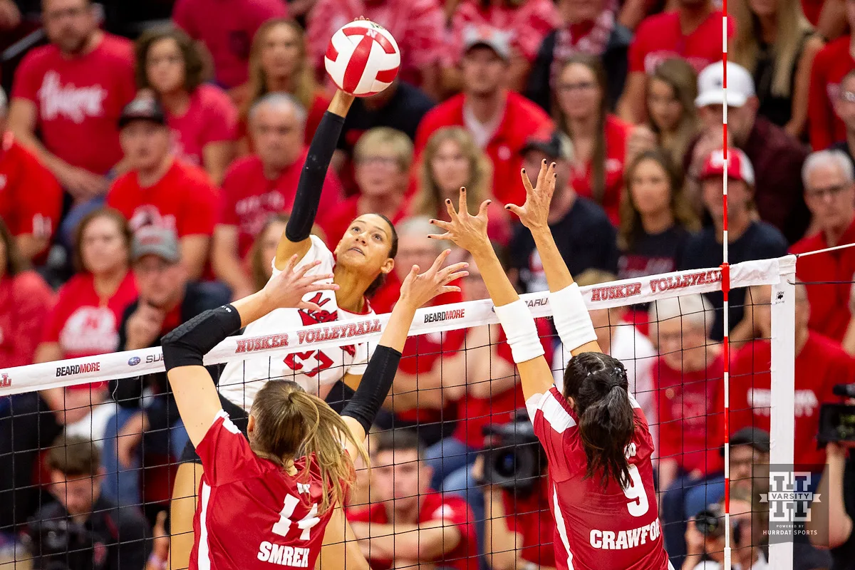 Nebraska Cornhusker Harper Murray (27) spikes the ball against Wisconsin Badgers Anna Smrek (14) and CC Crawford (9) in the fourth set during a college volleyball match on Saturday, October 21, 2023, in Lincoln, Nebraska. Photo by John S. Peterson.