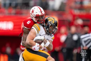 Nebraska Cornhuskers defensive back Quinton Newsome (6) wraps up the Iowa Hawkeyes ball carrier during a game in Lincoln, NE November 24th 2023. Photo by Eric Francis