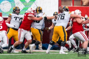Nebraska Cornhuskers defensive lineman Ty Robinson (9) knocks the ball loose from Iowa Hawkeyes quarterback Deacon Hill (10) during a game in Lincoln, NE November 24th 2023. Photo by Eric Francis