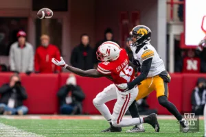 Nebraska Cornhuskers wide receiver Malachi Coleman (15) reaches for the ball while Iowa Hawkeyes defensive back Deshaun Lee (8) defends during a game in Lincoln, NE November 24th 2023. Photo by Eric Francis