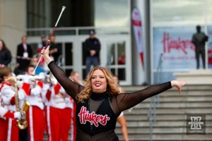 Nebraska Cornhusker baton twirler performs for the fans at the Ujnity Walk before the football game against the Maryland Terrapins on Saturday, November 11, 2023, in Lincoln, Nebraska. Photo by John S. Peterson.