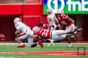 Nebraska Cornhusker linebacker Javin Wright (33) grabs on to Maryland Terrapins receiver C. Dyches in the second quarter during the football game on Saturday, November 11, 2023, in Lincoln, Nebraska. Photo by John S. Peterson.