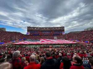 A football sized American flag unfurled for the National Anthem and Veteran's Day celebration before the football game between the Nebraska Cornhuskers and the Maryland Terrapins  on Saturday, November 11, 2023, in Lincoln, Nebraska. Photo by John S. Peterson.