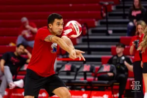 Nebraska Cornhusker assistant coach Jaylan Reyes digs the ball for warm-up before taking on the Illinois Fighting Illini during the volleyball match on Sunday, November 12, 2023, in Lincoln, Nebraska. Photo by John S. Peterson.