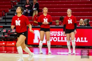 Nebraska Cornhusker Maisie Boesiger (7) and Nebraska Cornhusker Laney Choboy (6) watch Nebraska Cornhusker Lexi Rodriguez (8) during warm-ups before taking on the Illinois Fighting Illini in a volleyball match on Sunday, November 12, 2023, in Lincoln, Nebraska. Photo by John S. Peterson.