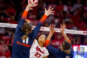 Nebraska Cornhusker Harper Murray (27) spikes the ball against Illinois Fighting Illini Cari Bohm (11) and Kayla Burbage (9) in the first set during the volleyball match on Sunday, November 12, 2023, in Lincoln, Nebraska. Photo by John S. Peterson.