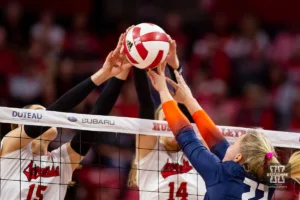 Nebraska Cornhusker Andi Jackson (15) and Ally Batenhorst (14) battle at the net against Illinois Fighting Illini Brooke Mosher (22) in the first set during the volleyball match on Sunday, November 12, 2023, in Lincoln, Nebraska. Photo by John S. Peterson.