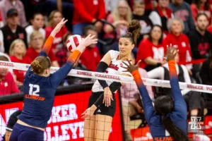 Nebraska Cornhusker Merritt Beason (13) spikes the ball against Illinois Fighting Illini Raina Terry (12) and Kennedy Collins (1) in the second set during the volleyball match on Sunday, November 12, 2023, in Lincoln, Nebraska. Photo by John S. Peterson.