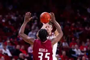 Nebraska Cornhusker guard Sam Hoiberg (1) makes a three point shot against Rider Bronc tyriek Weeks in the first half during the basketball game on Monday, November 13, 2023, in Lincoln, Nebraska. Photo by John S. Peterson.