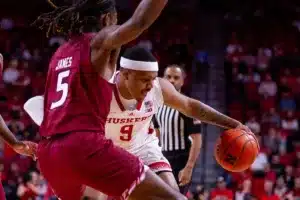 Nebraska Cornhusker guard Jarron Coleman (9) drives into Rider Bronc forward Mervin James (5) in the first half during the basketball game on Monday, November 13, 2023, in Lincoln, Nebraska. Photo by John S. Peterson.