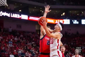 Nebraska Cornhusker guard Keisei Tominaga (30) makes a layup against Stony Brook Seawolf guard Jared Frey (24) in the first half  during the basketball game on Wednesday, November 15, 2023, in Lincoln, Nebraska. Photo by John S. Peterson.