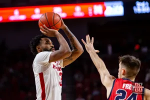 Nebraska Cornhusker guard Brice Williams (3) makes a jumpshot against Stony Brook Seawolf guard Jared Frey (24) in the second half during the basketball game on Wednesday, November 15, 2023, in Lincoln, Nebraska. Photo by John S. Peterson.