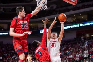 Nebraska Cornhusker guard Keisei Tominaga (30) drive to the basket against Stony Brook Seawolf guard Toby Onyekonwu (3) in the second half during the basketball game on Wednesday, November 15, 2023, in Lincoln, Nebraska. Photo by John S. Peterson.