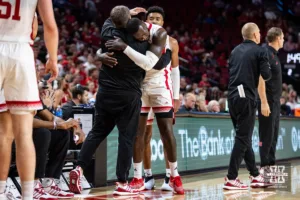 Nebraska Cornhusker forward Juwan Gary (4) gives assistant coach Adam Howard a hug after coming out at the end of the game against the Stony Brook Seawolves during the basketball game on Wednesday, November 15, 2023, in Lincoln, Nebraska. Photo by John S. Peterson.