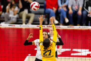 Nebraska Cornhusker Harper Murray (27) and Michigan Wolverine Kendall Murray (27) battle at the net in the first set during the volleyball match on Friday, November 17, 2023, in Lincoln, Nebraska. Photo by John S. Peterson.