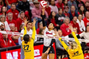 Nebraska Cornhusker Harper Murray (27) tips the ball over Michigan Wolverine Kendall Murray (27) in the first set during the volleyball match on Friday, November 17, 2023, in Lincoln, Nebraska. Photo by John S. Peterson.