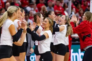 Nebraska Cornhuskers celebrate their win over the Michigan Wolverines in three sets during the volleyball match on Friday, November 17, 2023, in Lincoln, Nebraska. Photo by John S. Peterson.