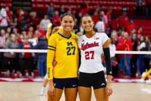 Sisters Nebraska Cornhusker Harper Murray (27) and Michigan Wolverine Kendall Murray (27) pose for a photo after the volleyball match on Friday, November 17, 2023, in Lincoln, Nebraska. Photo by John S. Peterson.