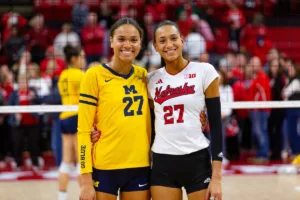 Sisters Nebraska Cornhusker Harper Murray (27) and Michigan Wolverine Kendall Murray (27) pose for a photo after the volleyball match on Friday, November 17, 2023, in Lincoln, Nebraska. Photo by John S. Peterson.