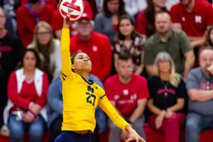 Michigan Wolverine Kendall Murray (27) spikes the ball against the Nebraska Cornhuskers in the third set during the volleyball match on Friday, November 17, 2023, in Lincoln, Nebraska. Photo by John S. Peterson.