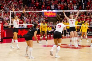Nebraska Cornhuskers celebrate the win over the Michigan Wolverines in three sets during the volleyball match on Friday, November 17, 2023, in Lincoln, Nebraska. Photo by John S. Peterson.