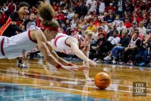 Nebraska Cornhusker forward Josiah Allick (53) and forward Rienk Mast (51) dive for the ball against the Oregon State Beavers in the second half during the basketball game on Saturday, November 18, 2023, in Sioux Falls, South Dakota. Photo by John S. Peterson.