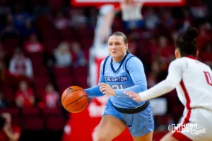 Creighton Bluejay guard Molly Mogensen (21) brings the ball down the court against Nebraska Cornhusker guard Darian White (0) in the second quarter during the basketball game on Sunday, November 19, 2023, in Lincoln, Nebraska. Photo by John S. Peterson.