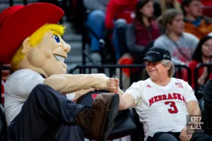 Nebraska Cornhusker mascot Herbie gives a Husker fan a fist bump during the college basketball game against the Duquesne Dukes on Wednesday November 22, 2023, in Lincoln, Neb. Photo by John S. Peterson.