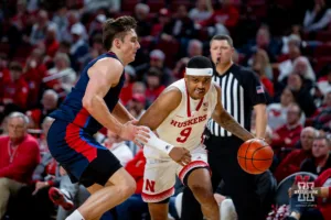Nebraska Cornhusker guard Jarron Coleman (9) dribbles the ball against Duquesne Duke forward Andrei Savrasov (23) in the second half during the college basketball game on Wednesday November 22, 2023, in Lincoln, Neb. Photo by John S. Peterson.