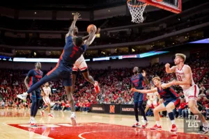 Nebraska Cornhusker forward Juwan Gary (4) makes a basket against Duquesne Duke forward David Dixon (2) in the second half during the college basketball game on Wednesday November 22, 2023, in Lincoln, Neb. Photo by John S. Peterson.