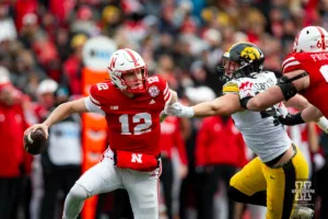 Nebraska Cornhusker quarterback Chubba Purdy (12) evades Iowa Hawkeye defensive lineman Kenneth Merrieweather (44) in the second quarter during the football game on Thursday, November 24, 2023, in Lincoln, Neb. Photo by John S. Peterson.