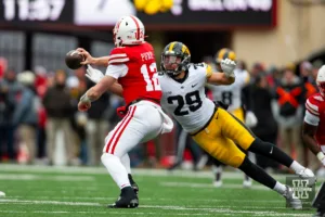 Nebraska Cornhusker quarterback Chubba Purdy (12) throws the ball away for a fumble against Iowa Hawkeye defensive back Sebastian Castro (29) in the second quarter in the second quarter during the football game on Thursday, November 24, 2023, in Lincoln, Neb. Photo by John S. Peterson.