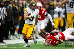 Iowa Hawkeye wide receiver Kaleb Brown (3) breaks a tackle against Nebraska Cornhusker linebacker Luke Reimer (4) in the second quarter during the football game on Thursday, November 24, 2023, in Lincoln, Neb. Photo by John S. Peterson.