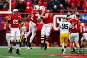 Nebraska Cornhusker quarterback Chubba Purdy (12) celebrates a touchdown pass with offensive lineman Ben Scott (66) in the second quarter against the Iowa Hawkeyes  during the football game on Thursday, November 24, 2023, in Lincoln, Neb. Photo by John S. Peterson.